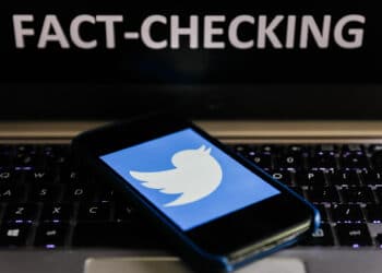 'Fact-checking' sign displayed on a laptop and Twitter logo displayed on a phone screen are seen in this illustration photo taken in Poland on June 13, 2020. European Commission officials said that Facebook, Twitter and Google should provide monthly fake news reports to prevent fake news about coronavirus pandemic. (Photo Illustration by Jakub Porzycki/NurPhoto via Getty Images)